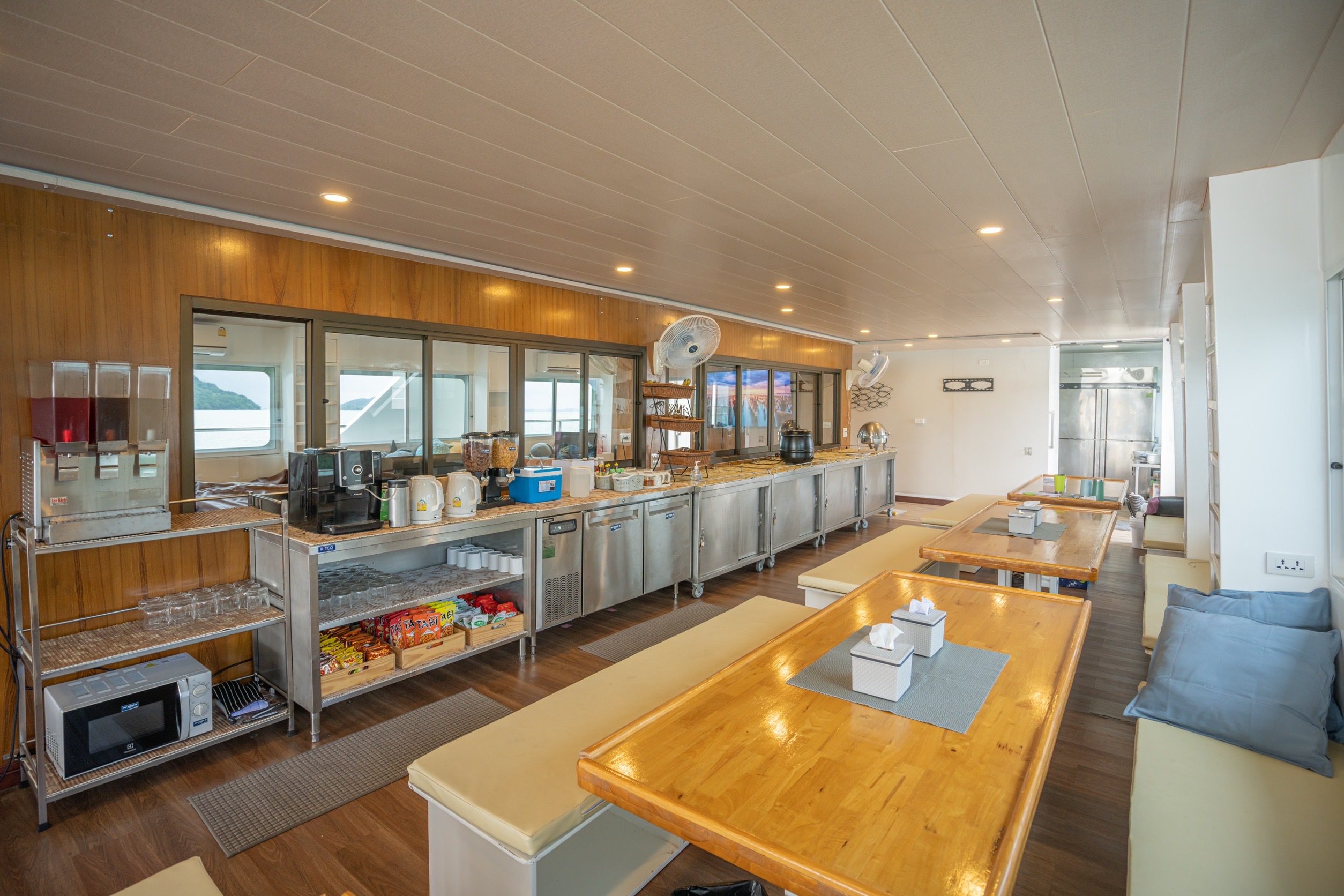 IMG_8265 Dining area on MV Koon 9 with wooden tables and a buffet counter